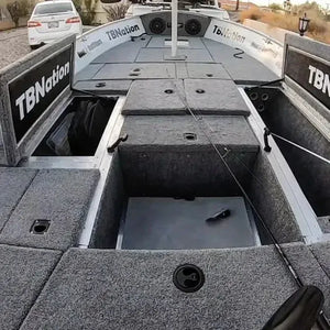 Gray 20 oz. premium cut pile marine carpet installed on a boat deck, showing storage compartments.