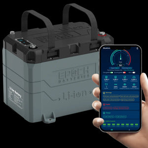 Gray Epoch 24V 100AH marine lithium battery with black straps, next to a hand holding a phone displaying the app.