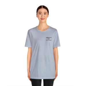 Light blue unisex t-shirt with "EXPERIENCE OVER EXTRAVAGANCE" text on the left chest.