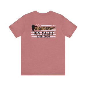 Heather peach unisex t-shirt with a distressed American flag design featuring "JON YACHT ESTB 2020" and a duck silhouette.