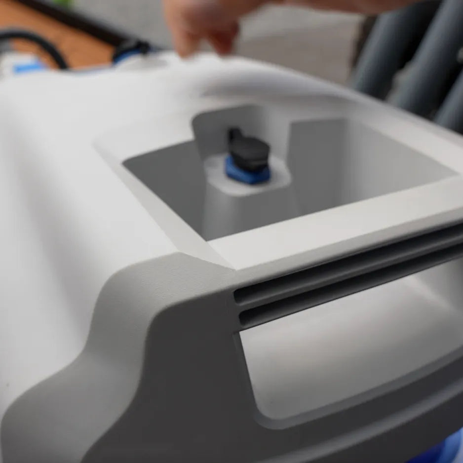 A person holds a white and blue EPropulsion Spirit 1.0 Plus 3HP electric outboard motor, showcasing its compact design.