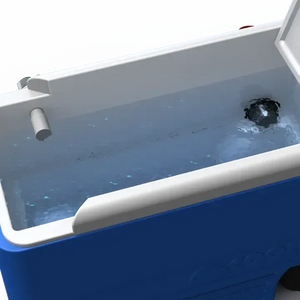 Blue cooler interior with white liner, filled with water, showing a black aerator nozzle and a white drain.