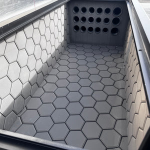 Dark gray Hydro Turf Pro Series EVA foam mat with a textured hexagonal pattern installed in a boat compartment.