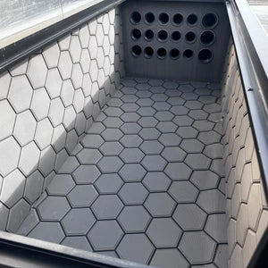 Dark gray Hydro Turf Pro Series EVA foam mat with a textured hexagonal pattern installed in a boat compartment.