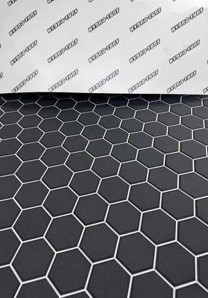 Black Hydro Turf Pro Series EVA foam mat with a textured hexagonal pattern and white outlines.