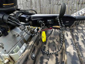 Braided black and gray paracord key lanyard with a yellow float and kill switch attached to a boat motor.