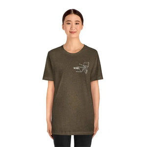 Woman wearing a brown MERC Tiller tee with a white outline graphic of a boat motor on the left chest.