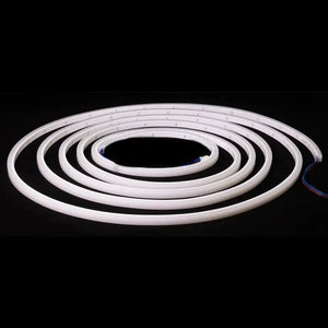 Coiled white MINI LED Neon Flex RGBW strip light with exposed red and blue wires.