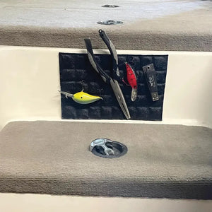 Black textured Magnalure Pad with fishing pliers, yellow and red lures, and a snip tool attached to a boat console.