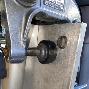 Black UHMW motor clamp spacer pucks installed on a silver outboard motor bracket.