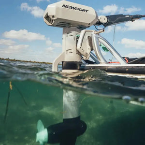 Newport NT600 6hp electric outboard motor, light gray, mounted on a boat with propeller submerged in clear water.
