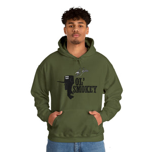Man wearing an olive green Ol' Smokey Hoodie with a 2-stroke engine graphic.