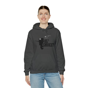 Woman smiling in a charcoal gray Ol' Smokey Hoodie with a two-stroke engine graphic.