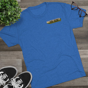 Blue tri-blend regular fit t-shirt with "JON YACHT" logo, styled with sneakers, plant, and glasses.