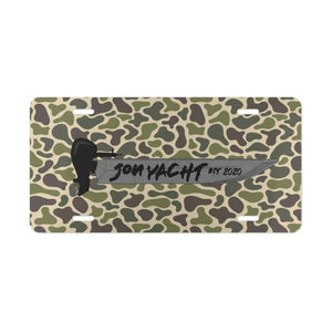 Aluminum license plate with a green and brown camouflage pattern, featuring a black boat and "JON YACHT EST 2020" text.