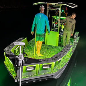 Green RGBW Plashlight strip illuminating a boat interior and surrounding water at night.