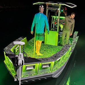Green RGBW Plashlight strip illuminating a boat interior and surrounding water at night.
