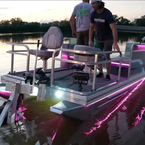 Pontoon boat with bright pink and white Plashlights EPIK LED underwater transom lights illuminating the water.