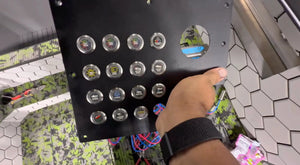 Black panel with 15 round, silver 22mm Plashlights REVERT switches, each with a unique icon.