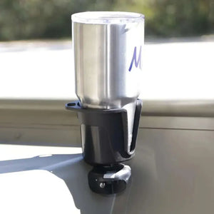 Black Railblaza DrinkHold with a silver tumbler, mounted on a light green surface.