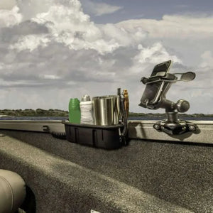 Black Railblaza Trackloader StarPort with phone holder and storage caddy mounted on a boat gunnel.