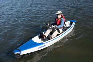 Man in a white and blue Sea Eagle kayak with a Bixpy K-1 motor and paddle.