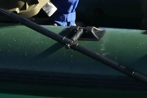 Black Sea Eagle oarlock with a tall pin, securing a black oar to a green inflatable boat.