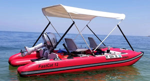 Red Sea Eagle FastCat12 inflatable catamaran with a white canopy, two seats, and a Honda outboard motor.