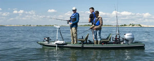 Three men fishing from a green Sea Eagle FishSkiff 16 inflatable boat with a Honda outboard motor.
