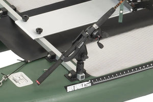 Black Scotty Gear Head track adapter holding a fishing rod on a green Sea Eagle kayak.