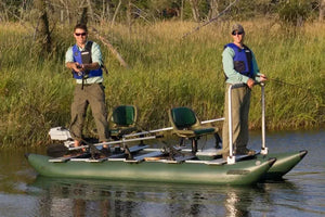 Two men fishing from a green Sea Eagle inflatable boat with two seats and multiple rod holders.