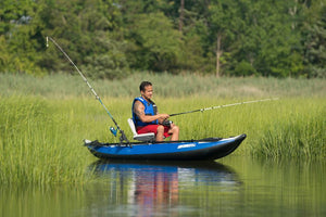 Man fishing from a blue Sea Eagle inflatable kayak with a white swivel seat and Scotty rod holders.