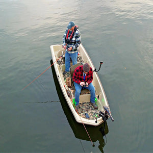 Two men fishing from a tan Sun Dolphin American 12 boat with a camouflage floor kit installed.