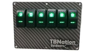 TBNation 6-gang carbon fiber hydro-dipped aluminum switch panel with six illuminated green rocker switches.