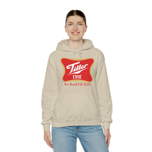Woman smiling in a beige "Tiller Time" cotton-polyester hoodie with a red and gold graphic.