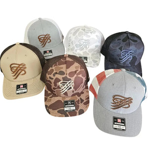 Six Richardson 112 trucker hats: tan, grey, two camo, black camo, and grey with red/white/blue stripes. All feature a "TTP" logo.
