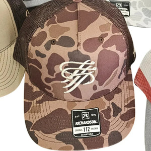 Brown camo trucker hat with white embroidered logo, brown mesh back, and Richardson tag.