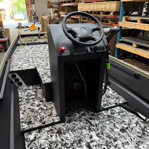 Control panel with steering wheel and buttons in a warehouse setting