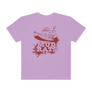 A light purple short-sleeve crewneck t-shirt featuring a red graphic print of a cartoon character in a boat with the text 'MUD RATS' underneath, displayed on a solid white background.