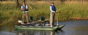 Two men fishing from a dark hunter green Sea Eagle 375fc FoldCat inflatable pontoon boat with Scotty rod holders.