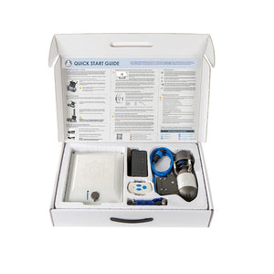 Open box containing electronic components and a quick start guide on a white background