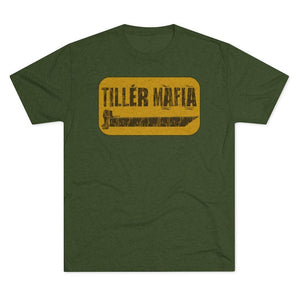 An olive green heather short-sleeve t-shirt with a distressed yellow graphic on the chest that reads 'TILLER MAFIA' above a large till tool, displayed on a solid white background.