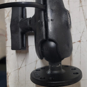 Close-up of the adjustable ball mount and lower pole of the Max It Out LEDs Premier Universal LED Stern Light, showing the circular mounting plate, tightening knob, and USCG certification print on the shaft.