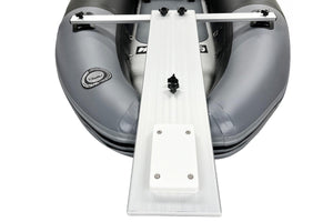 A white aluminum bow ramp and step ladder attachment shown mounted on the front of a gray inflatable dinghy, photographed from a top-down angle against a white background.