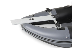 A close-up studio shot of a gray and black sea eagle nflatable boat with a white metal mounting bracket attached near the stern, on a white background.