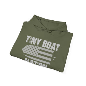 Folded green hoodie with 'Tiny Boat Nation' text and American flag design on a white background