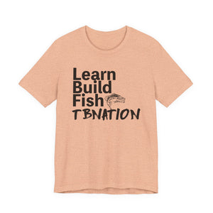 Peach t-shirt with black text and fish graphic on a white background