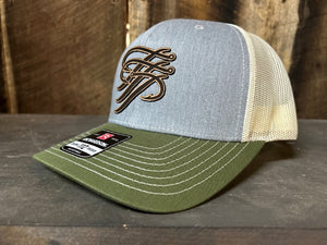 Trucker hat with green brim and gray mesh back on a wooden surface