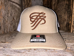 Beige trucker hat with brown logo on a wooden surface