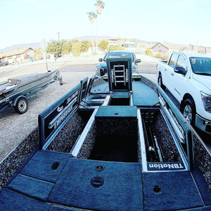 Dark gray cut pile marine carpet installed in a boat, showcasing storage compartments and a seamless finish.